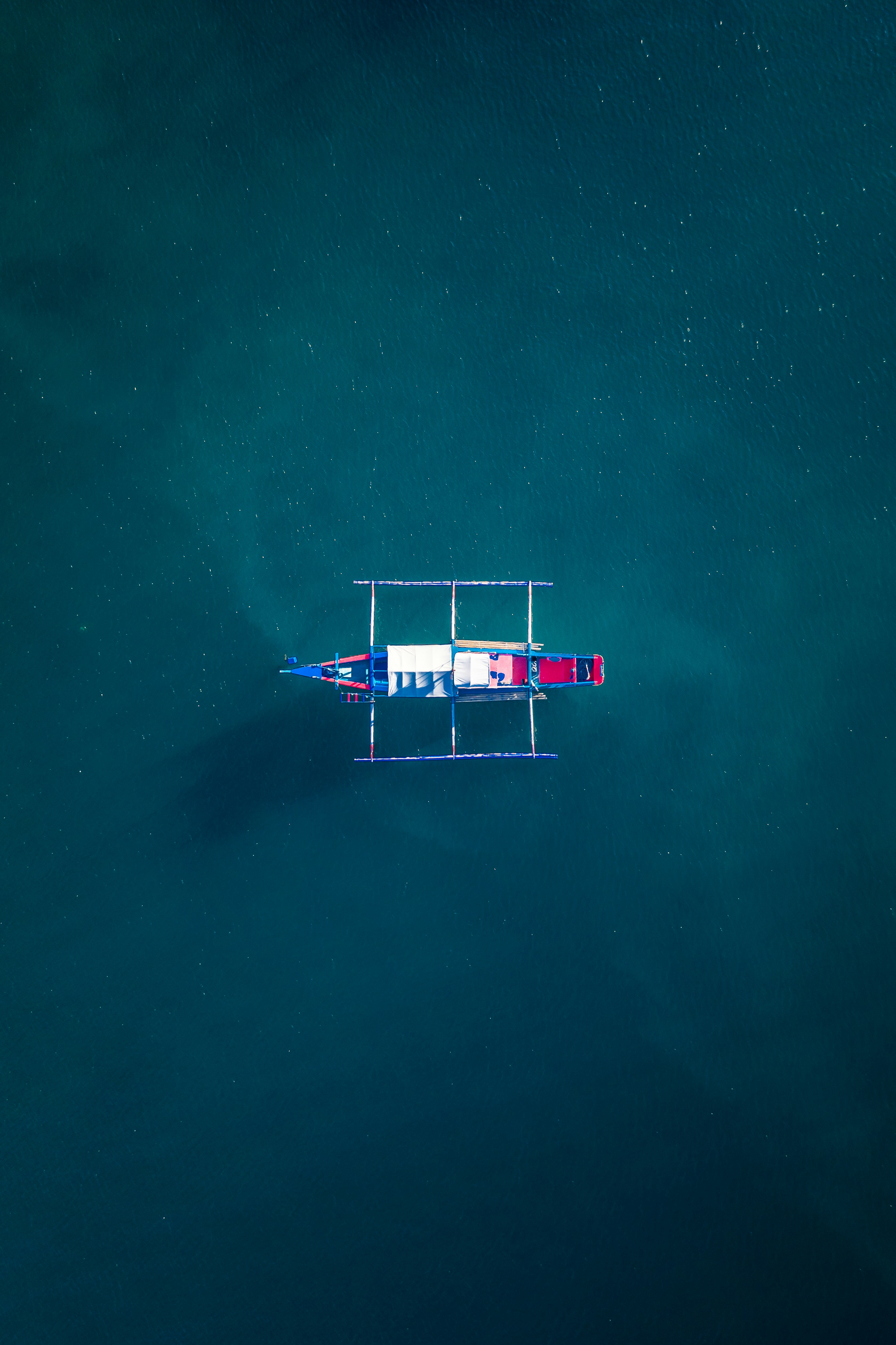 white and red boat on body of water